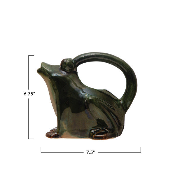 A green stoneware watering pitcher designed to resemble a frog.